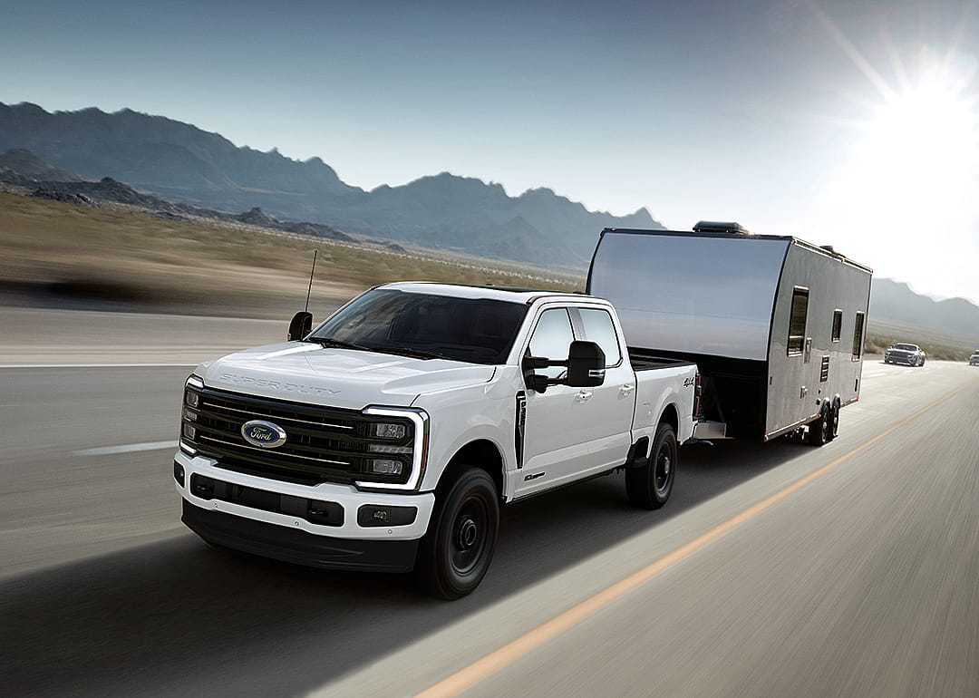 A front view of a white 2025 Ford F-350 Super Duty on the road.