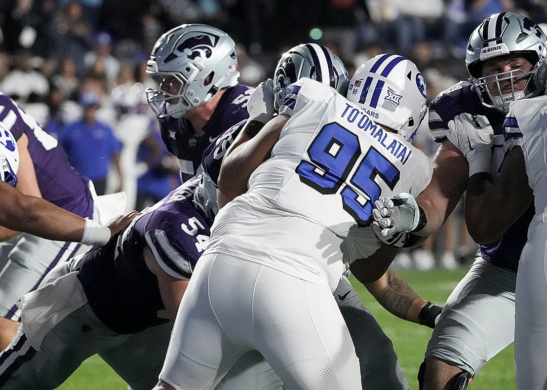 Luke To'omalatai (95) defends during the game between the Brigham Young Cougars and the Kansas State Wildcats in Provo.