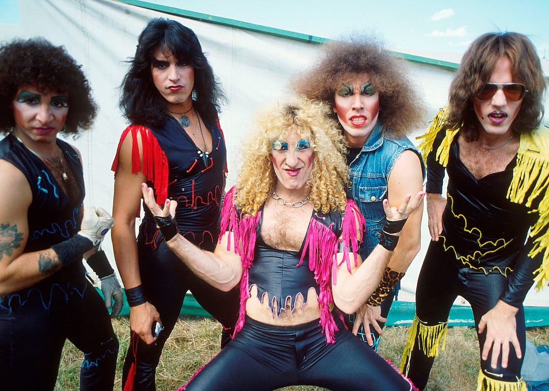 AJ Pero, Eddie Ojeda, Dee Snider, Mark Mendoza, and JJ French of Twisted Sister pose backstage at Reading Festival, in 1982.