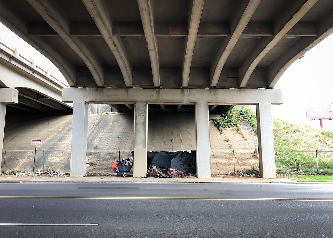 Homeless person has set up a tent and shelter underneath an underpass in Alabama.