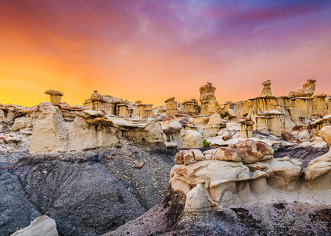 The Bisti/De-Na-Zin Wilderness in New Mexico during sunset.
