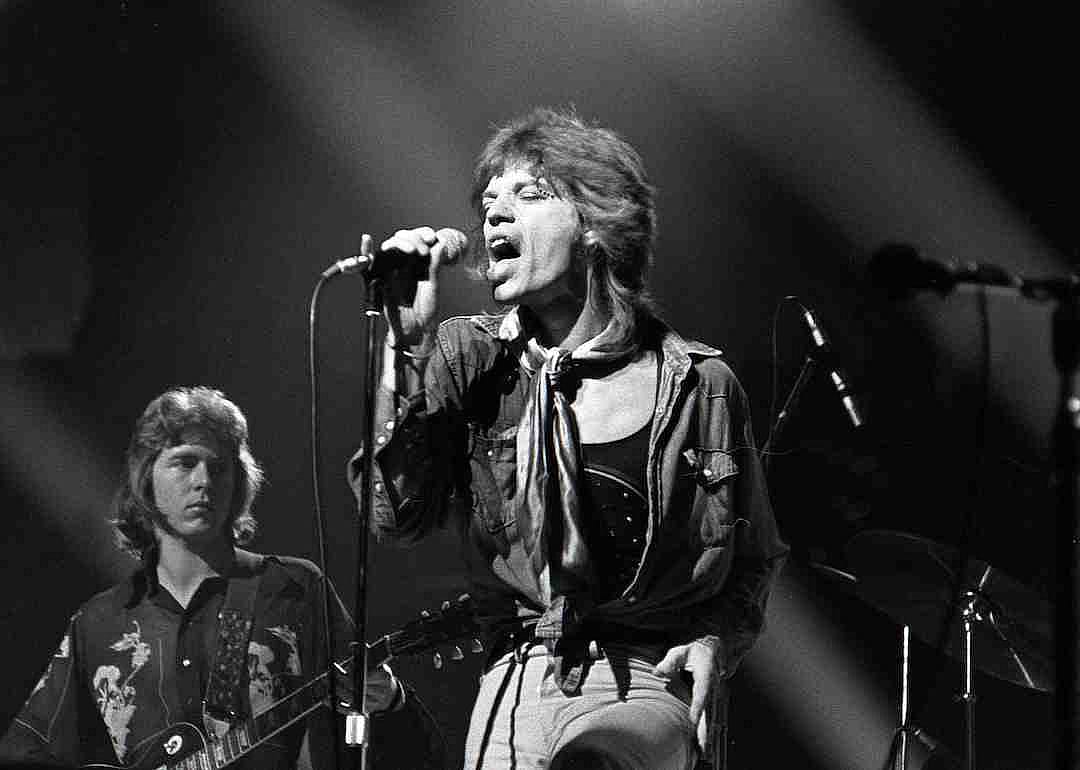 Mick Taylor and Mick Jagger performing with The Rolling Stones in 1976.