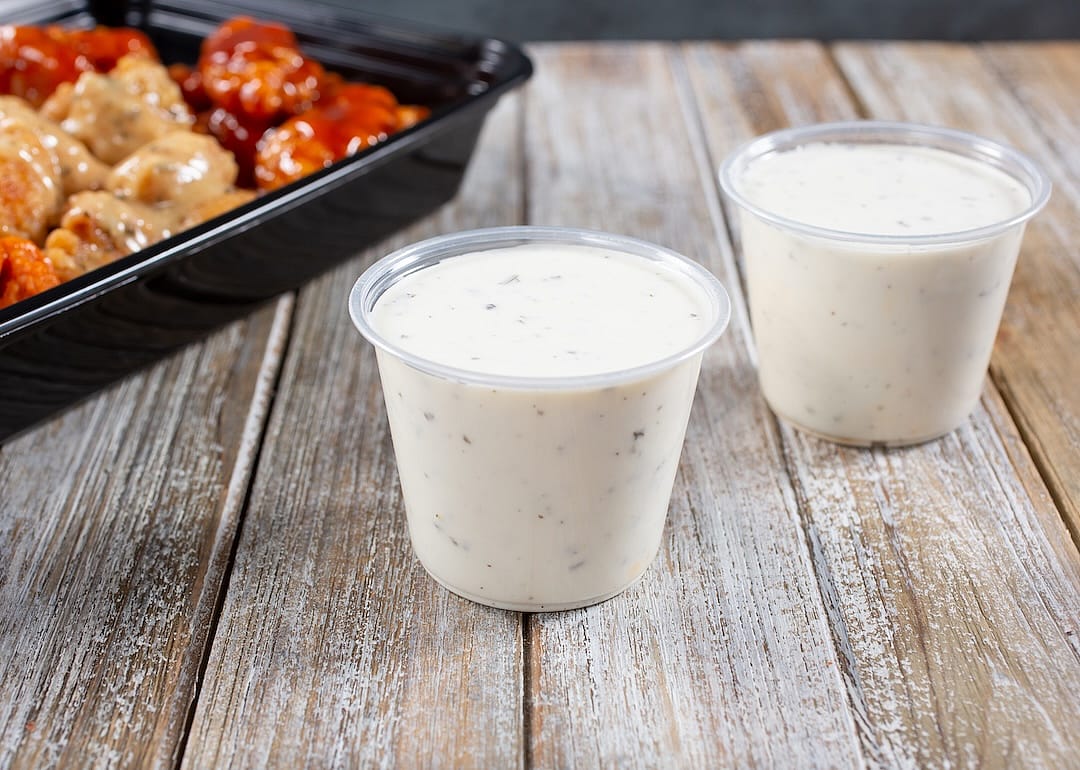 Ranch served in plastic cups with appetizer.