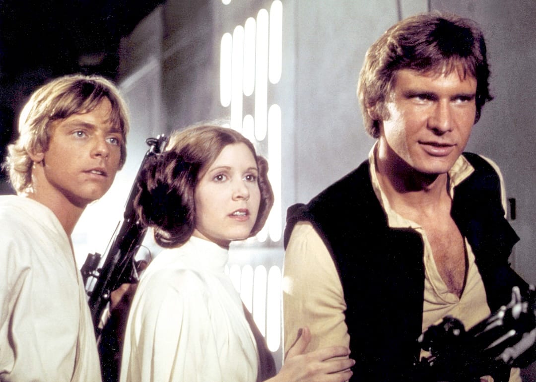 Mark Hamill, Carrie Fisher, and Harrison Ford on the set of "Star Wars: Episode IV – A New Hope," written and directed by George Lucas.