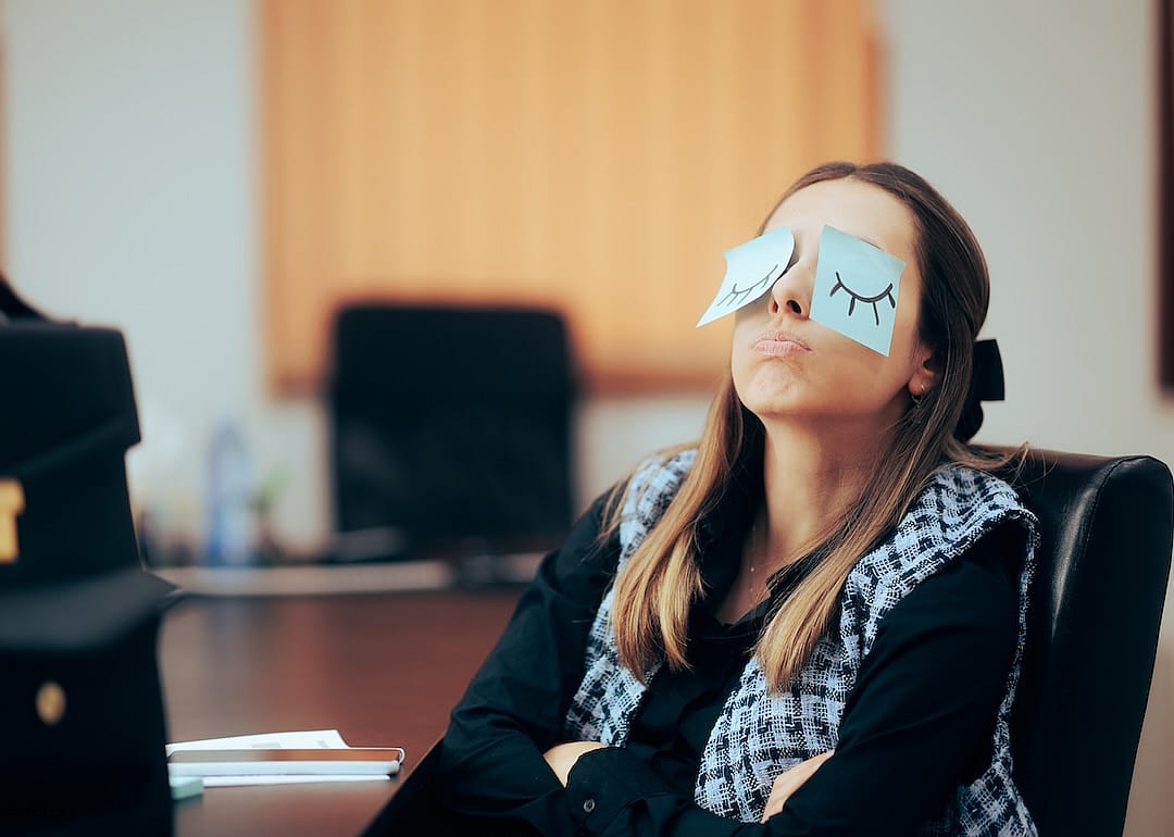 Tired office worker feeling sleepy on the job.