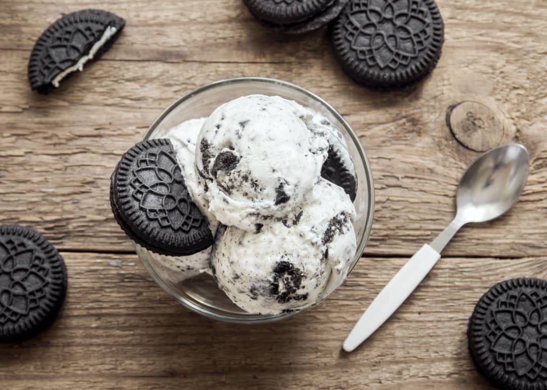 Cookies and cream ice cream bowl on wooden background.