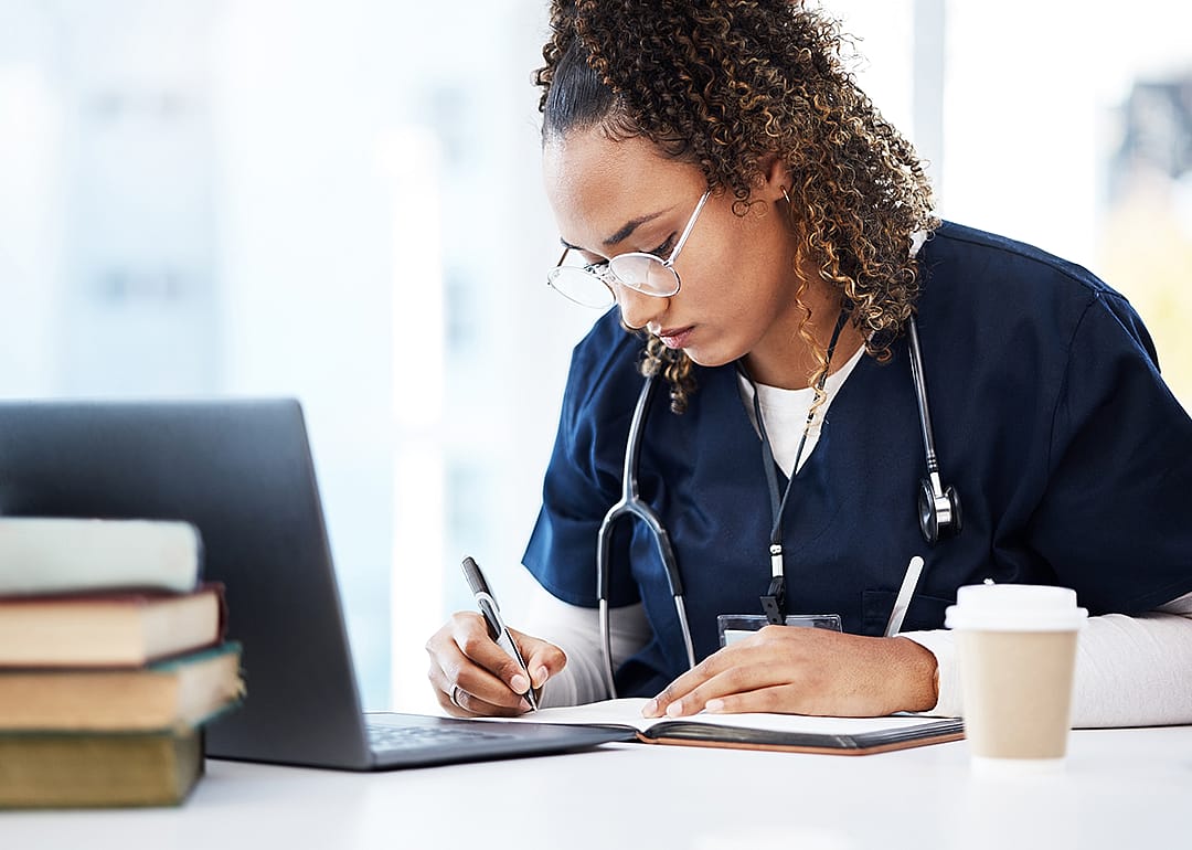 Nursing student taking notes.
