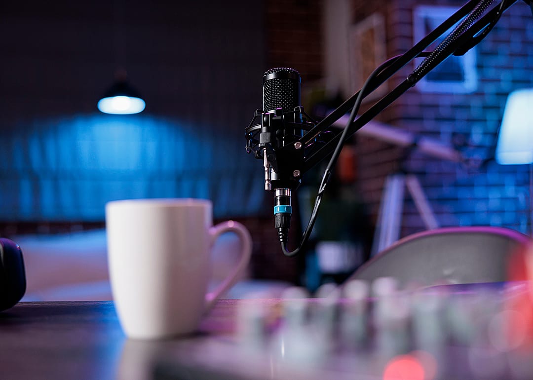 Desk in home production studio with professional podcasting tools.