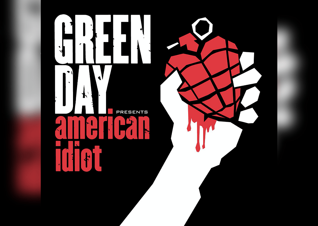 An illustrated white hand holding a red grenade shaped like a heart with blood running down the wrist.