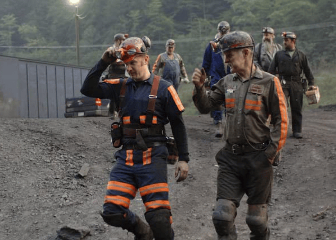 Host Morgan Spurlock walks with miners