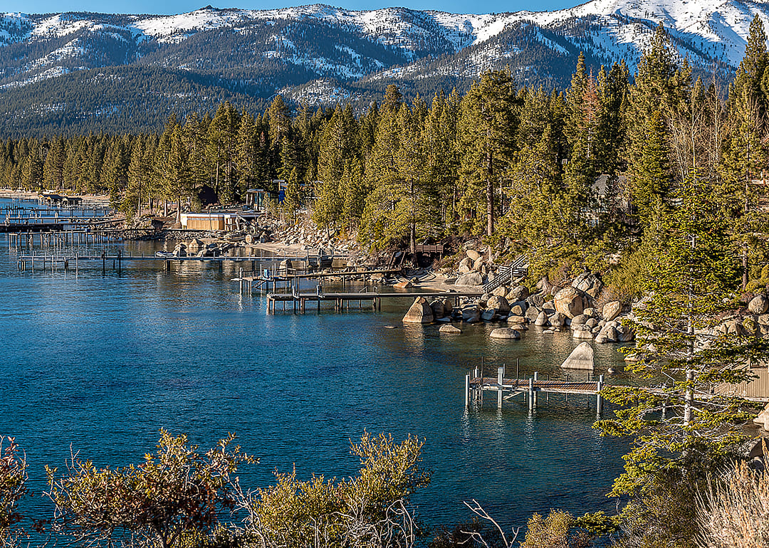 Elevated view of waterfront docks on scenic lakes.