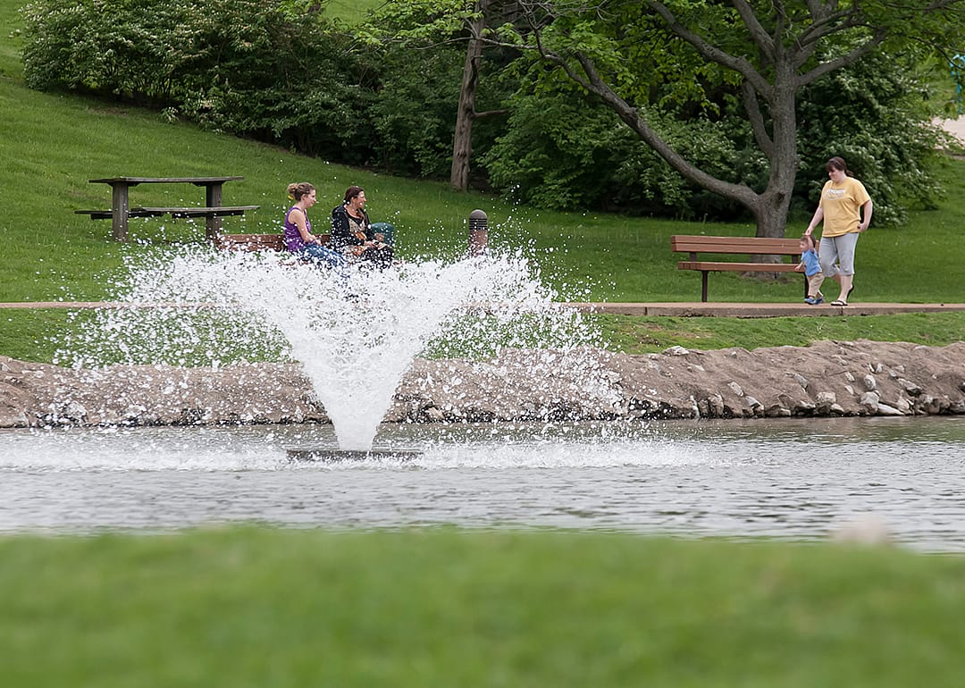 Family and children walking in park.