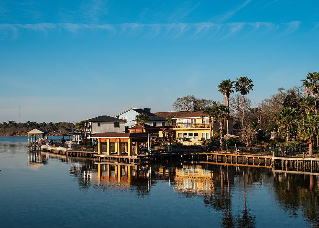 View of waterfront houses before sunset in Taylor Lake Village.