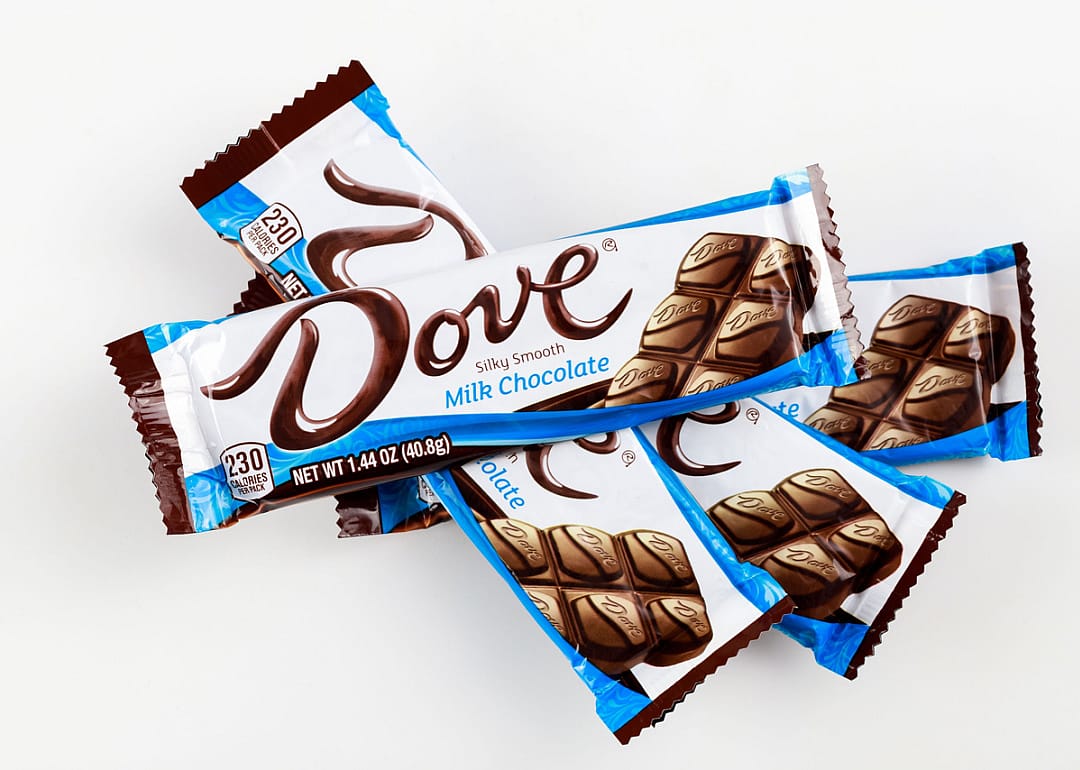 Dove milk chocolate bars on white background.