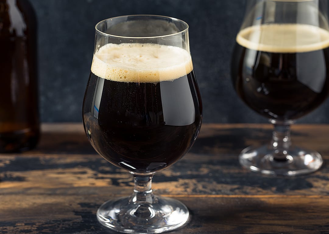 Dark porter in a glass on wooden bar.