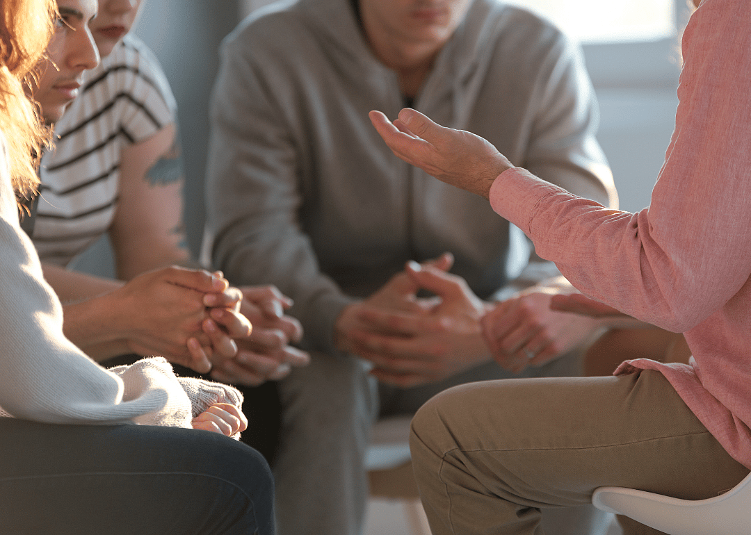 Therapist talking to a group of teenagers.
