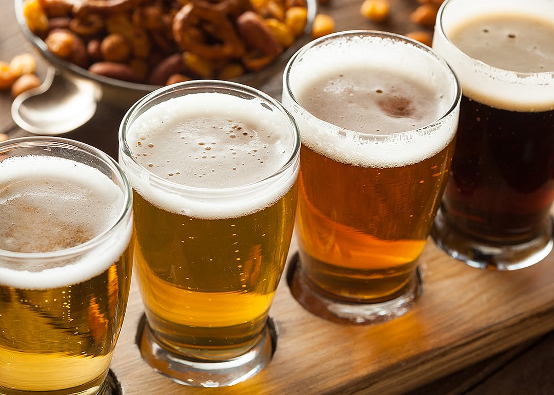 Assorted beers in a flight ready for tasting.