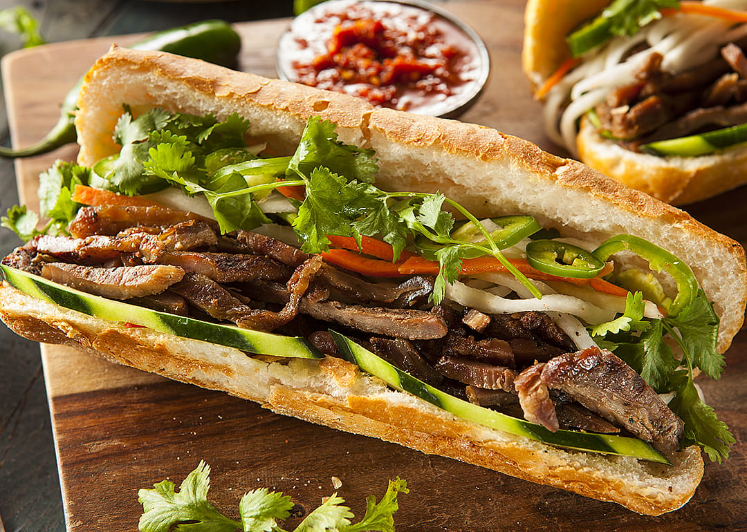 Banh mi sandwich with cilantro and daikon on a crusty roll.