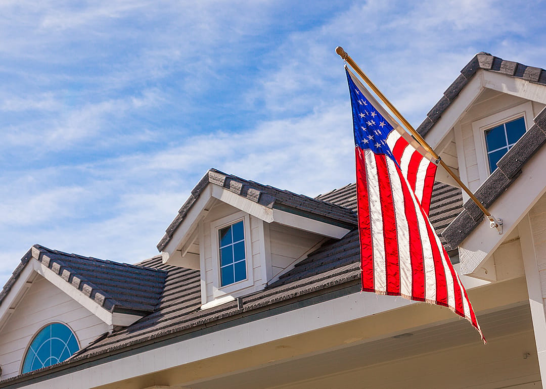 American flag hanging from house facade.
