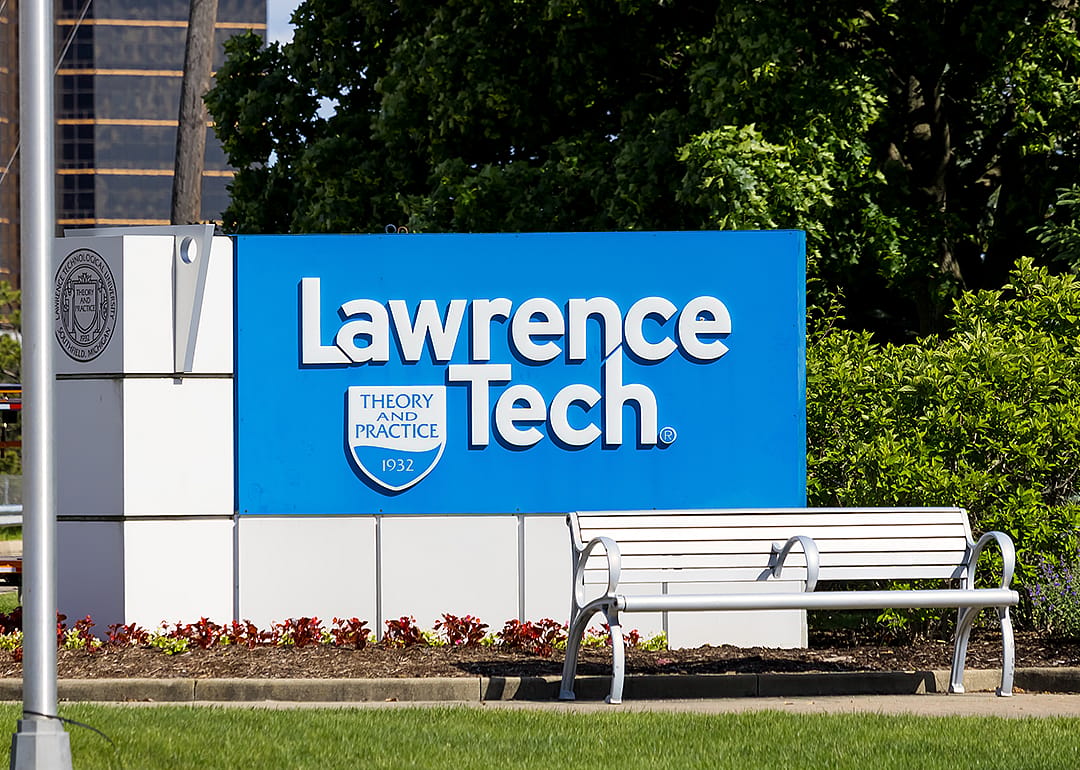 Entrance sign to Lawrence Tech with bench.