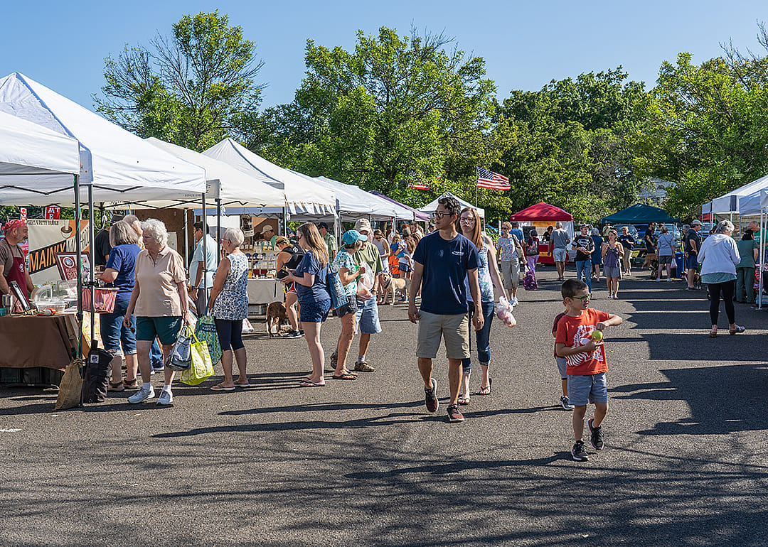 Families shopping at the Lansdale Farmer’s Market in summer.