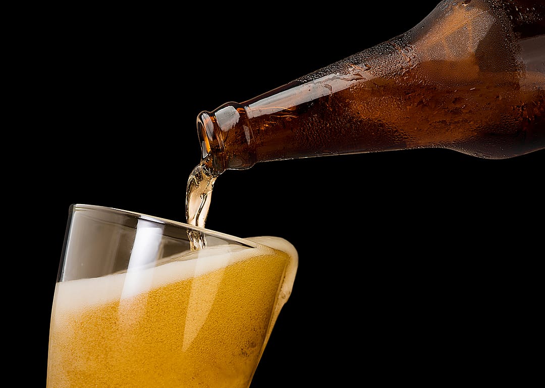 Pouring beer into mug or glass.