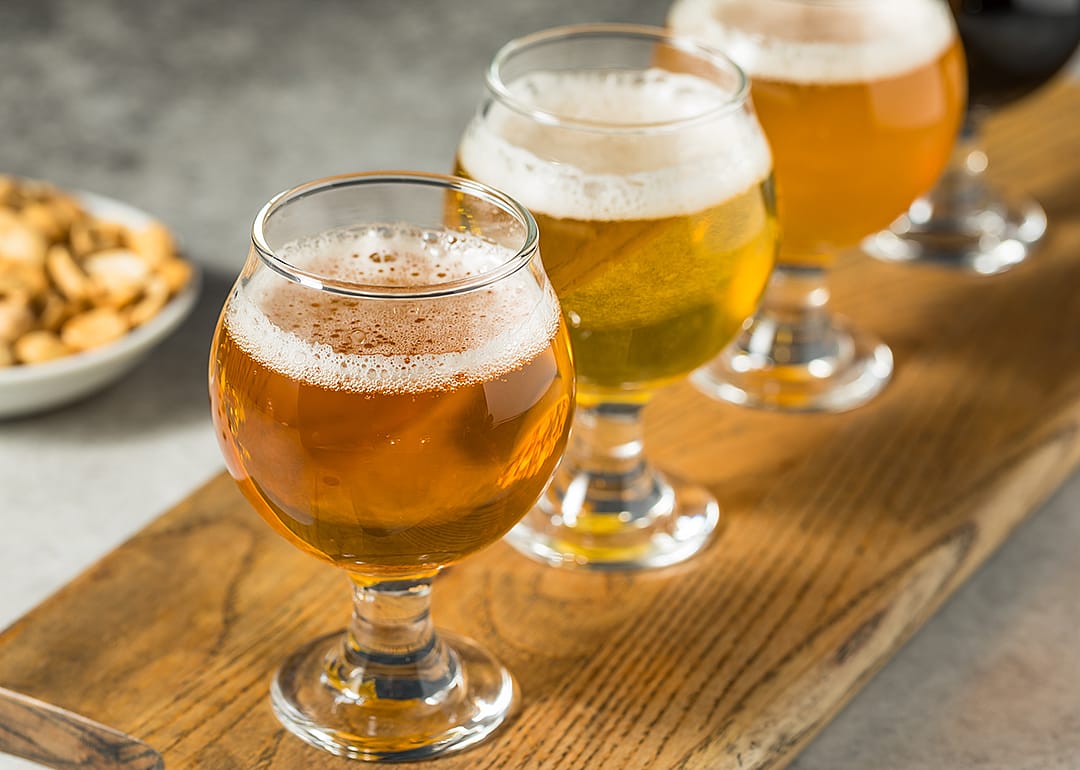 Glasses of golden beer in a flight.