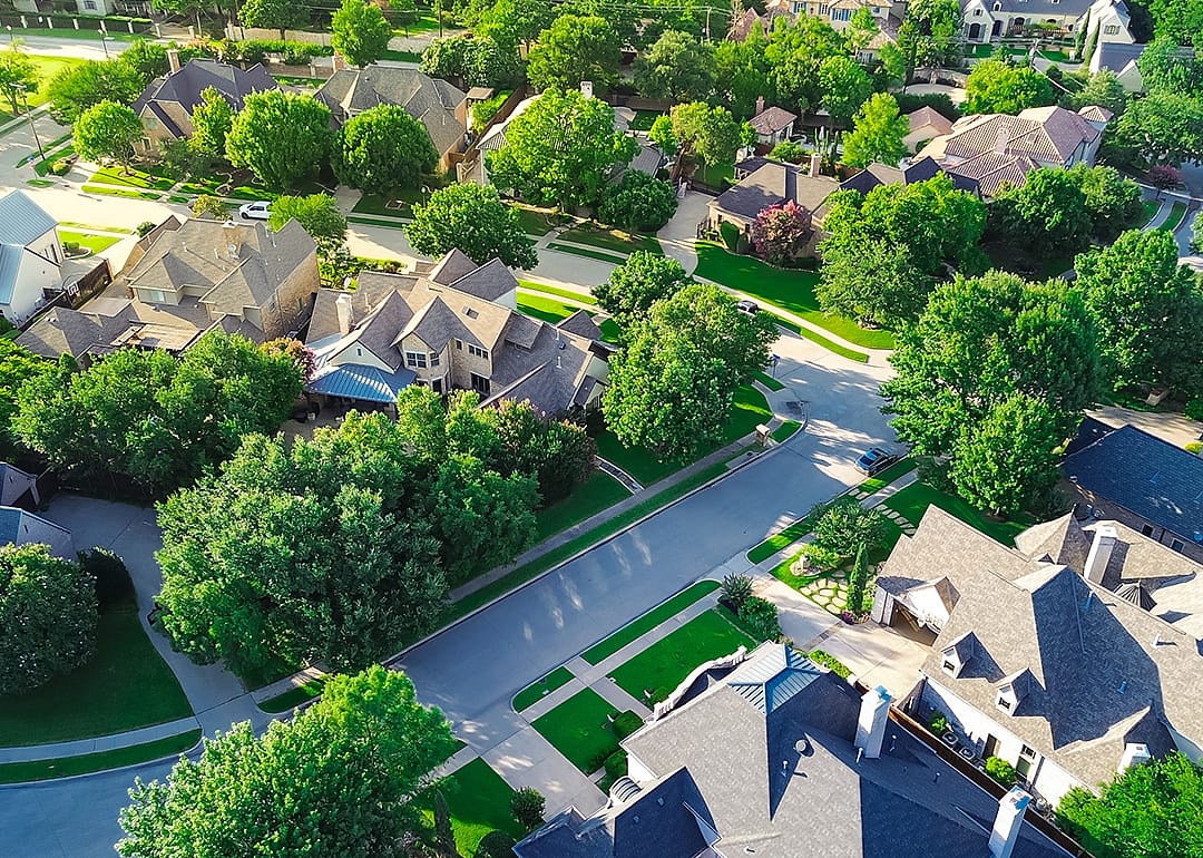Aerial upscale suburban single family homes.