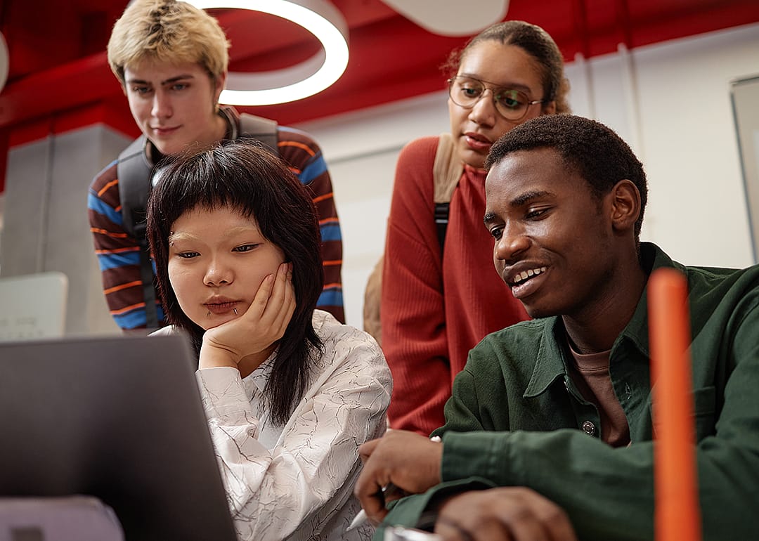 Group of students looking at laptops computer.