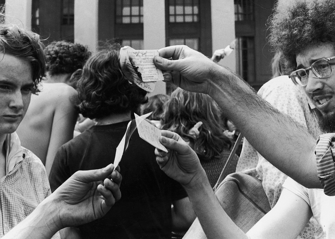 Anti-war demonstrators burn their draft cards.