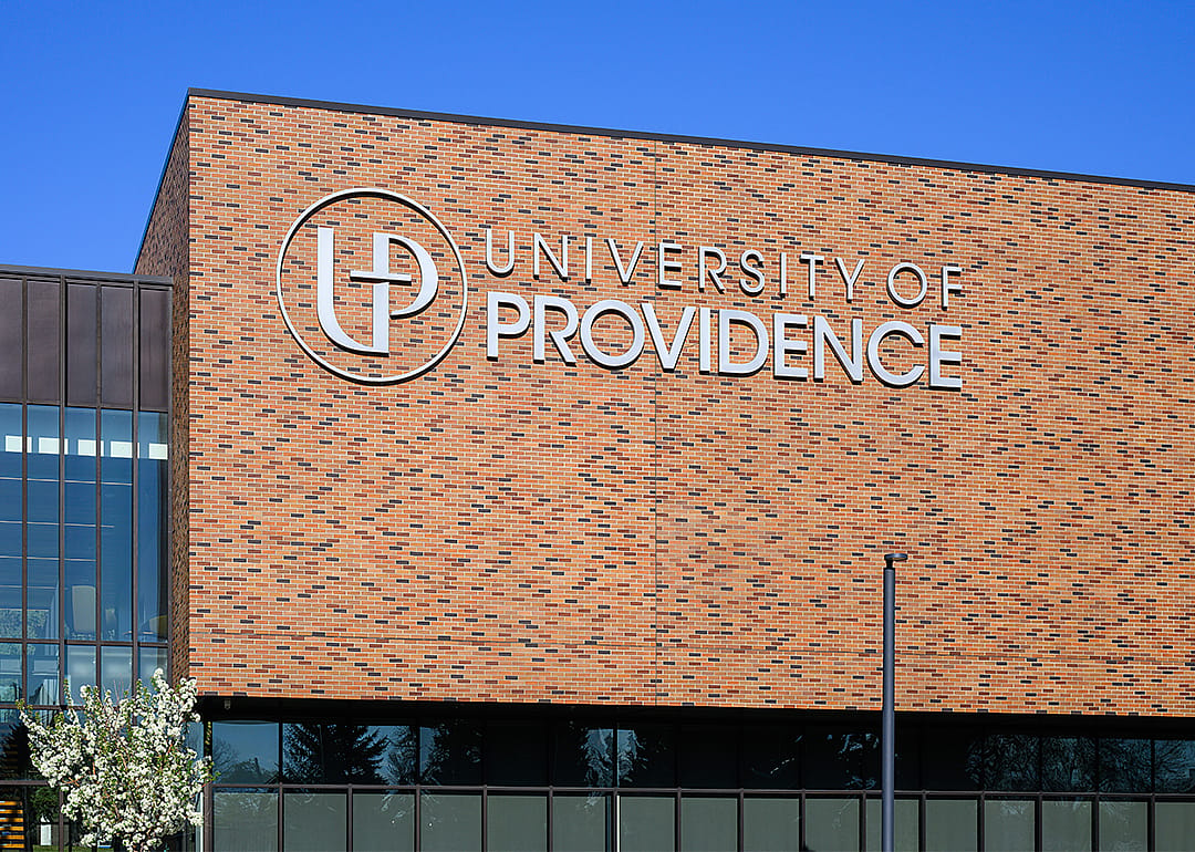Sign on brick wall at University of Providence.