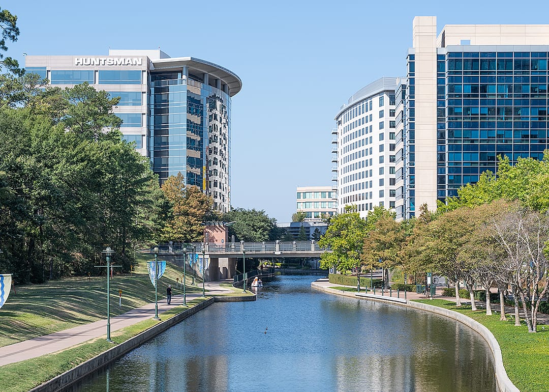 A river winding its way through the business district of an urban community.