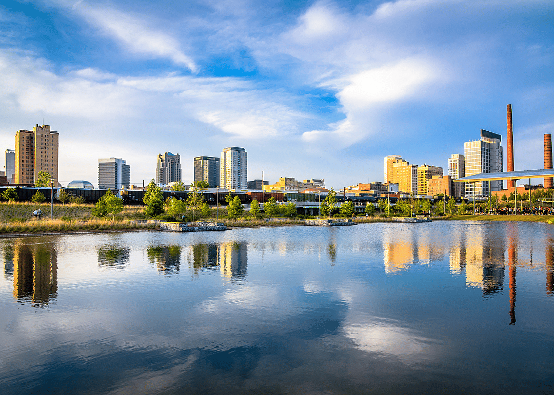 A view of a city situated by the river with tall buildings.