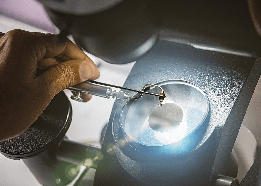 A diamond is closely examined in a laboratory.