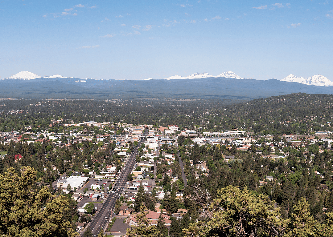 Aerial view of a city with mountains in the background.