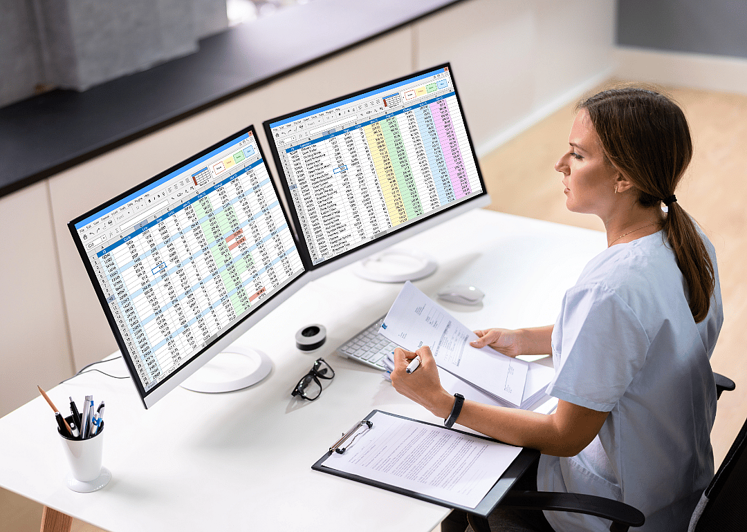 A medical professional doing billing on a computer.