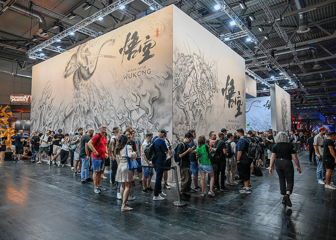 Gaming enthusiasts waiting in front of the stand for Black Myth: Wukong at a gaming fair.