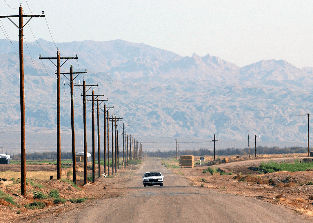 A car driving down a remote road in 2003.