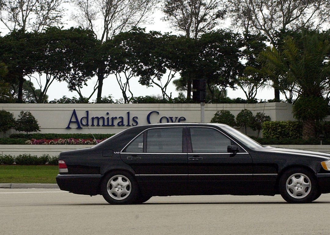 An automobile passing the gated community of Admira.