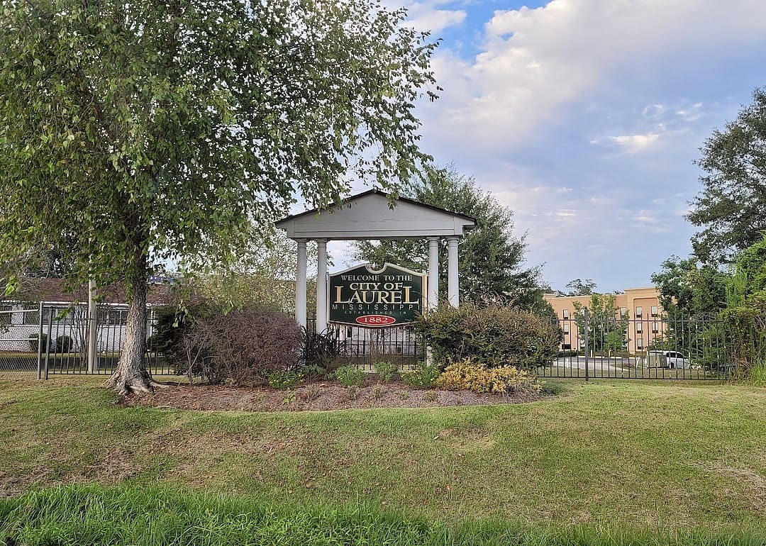 A sign reads "Welcome to the City of Laurel, Mississippi."