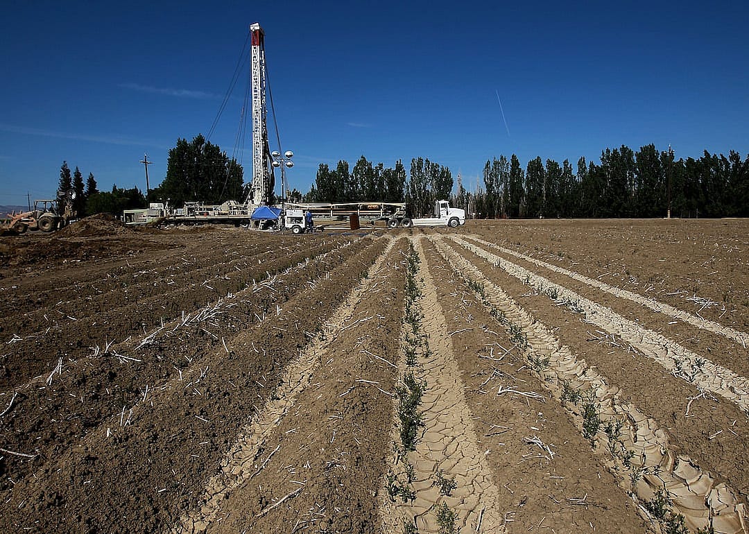 Workers drill a new well at a farm near Mendota, California.