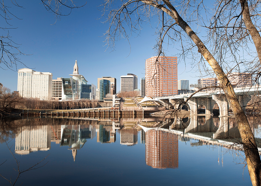 A city skyline with white bridge over the river. 