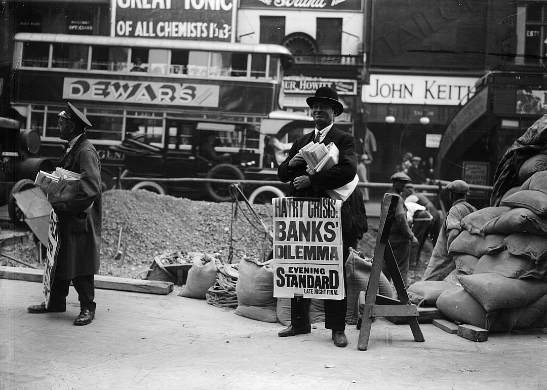 Newspaper sellers on a London street.