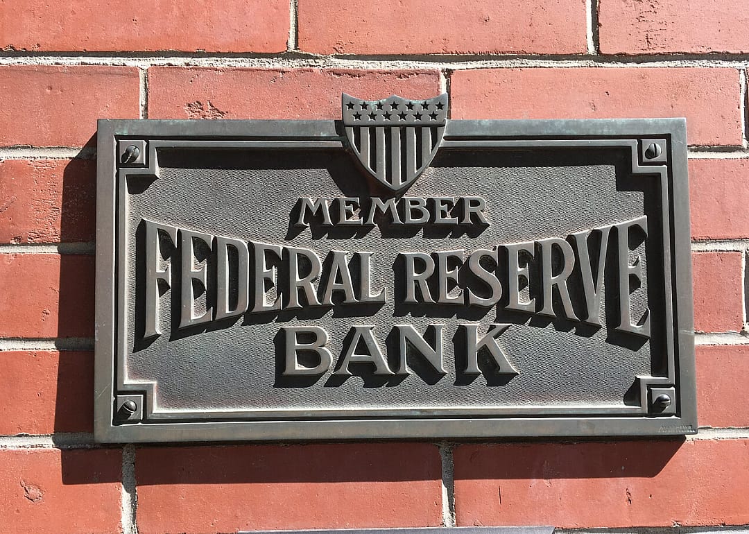 A plaque on a wall that designates a bank is a member of the Federal Reserve.