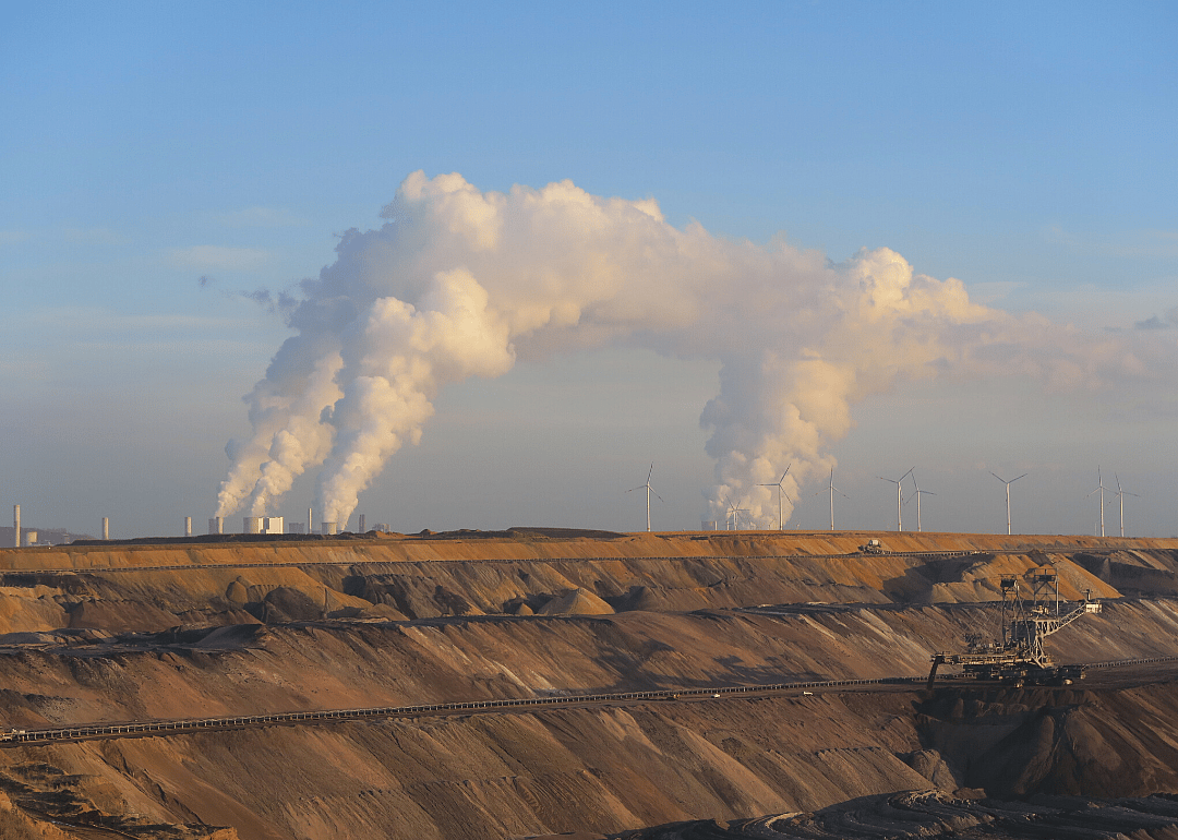 Power plants with smokestacks in the distance.