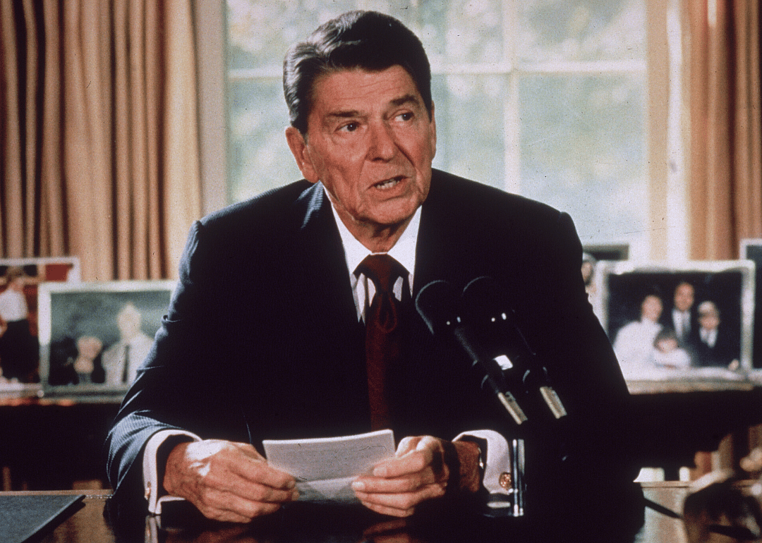 President Regan signs a document.