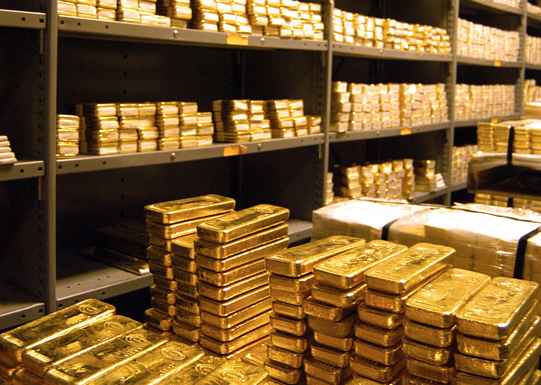 Gold bars stacked on shelves.