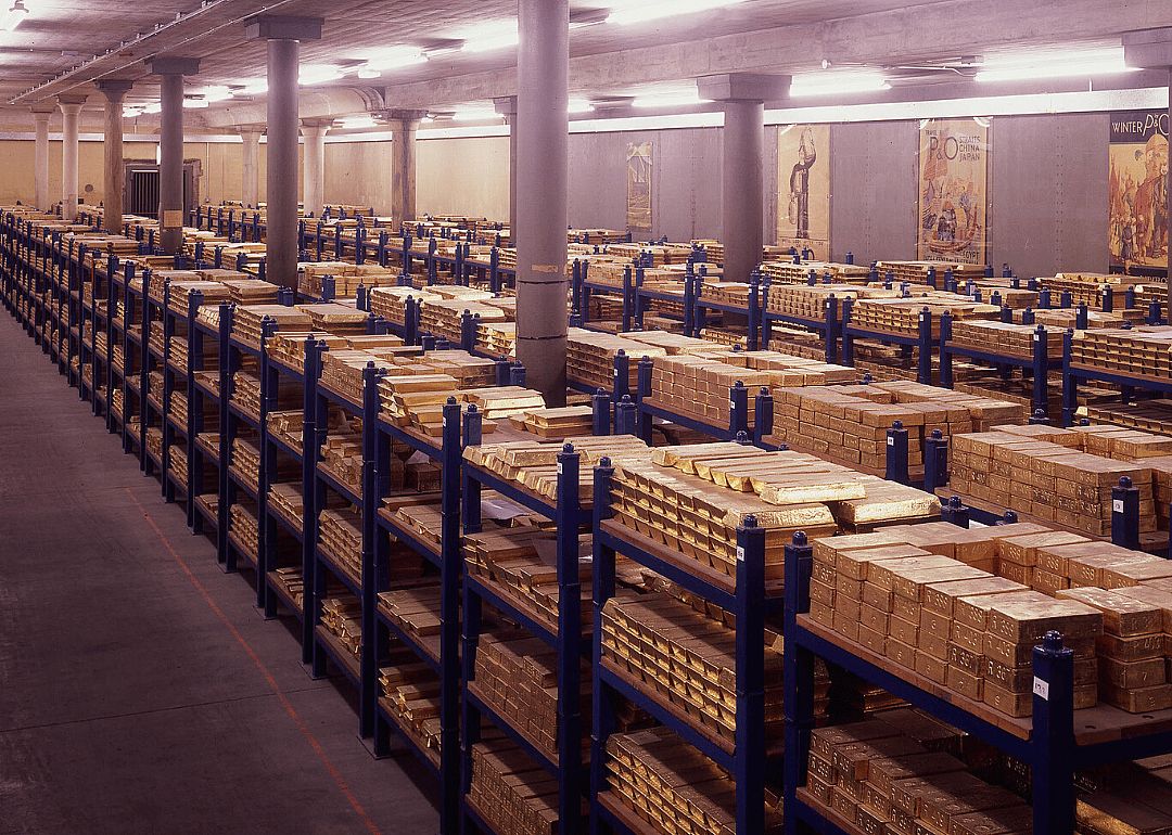 Gold bullion bars fill a vault.
