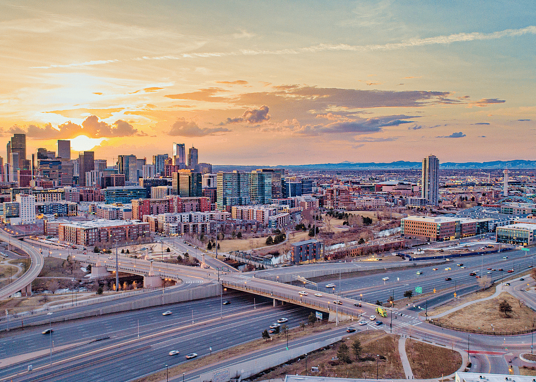 An aerial view of a city and highways at dusk.
