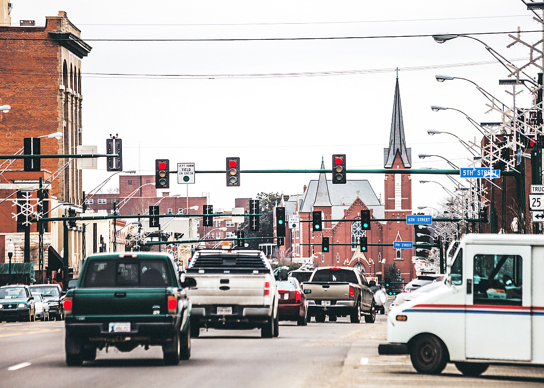 Traffic in a town decorated for holidays.
